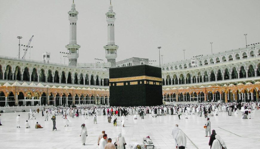 a group of people standing around a large building